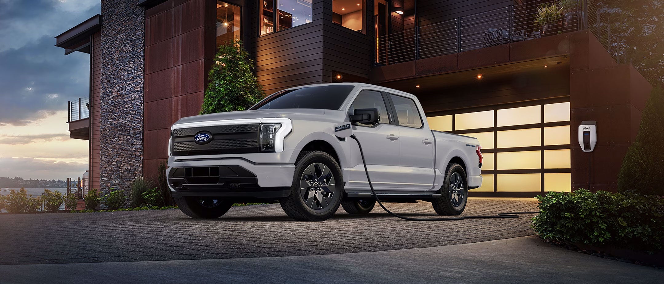 A Ford F-150 Lightning charging at home in the driveway